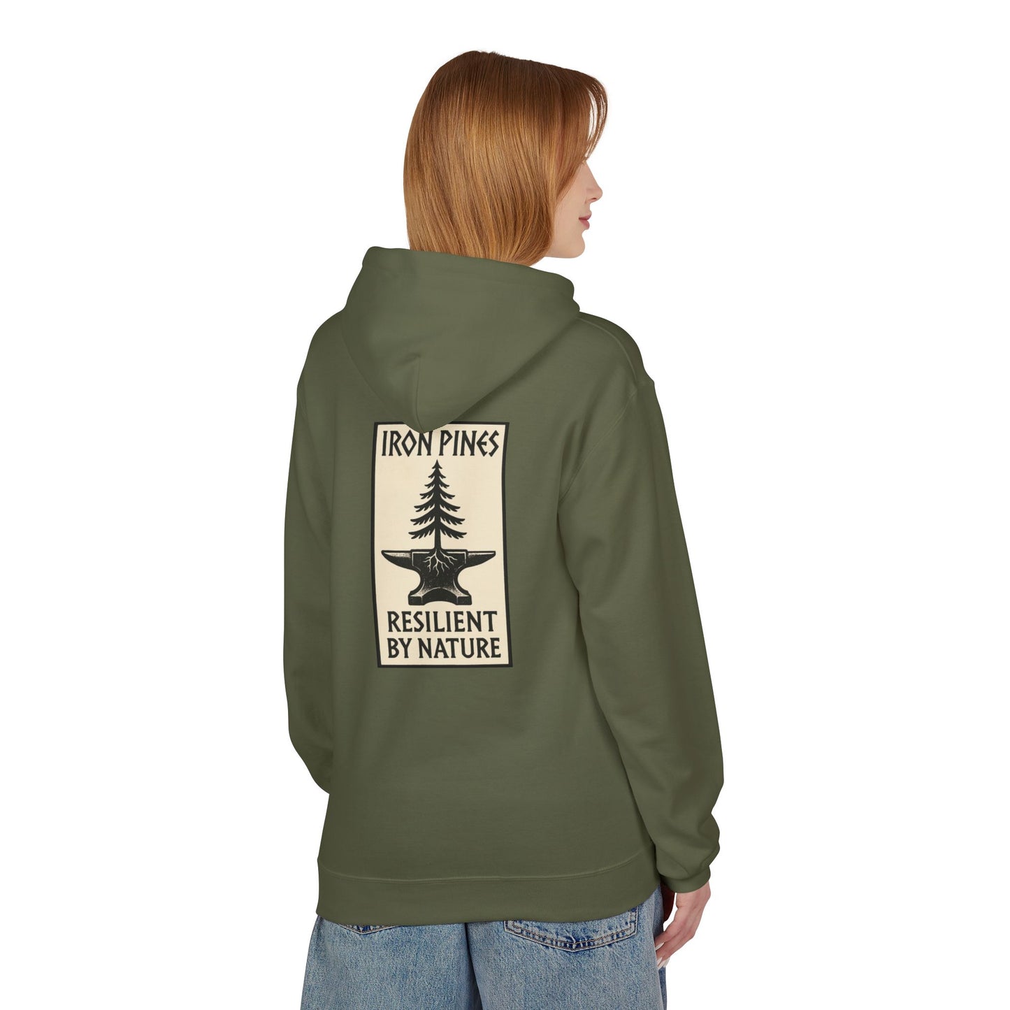 A person with straight, shoulder-length hair stands facing away, wearing The Iron Pines Hoodie by Printify in olive green—a midweight fleece featuring a large back patch with a tree illustration and IRON PINES RESILIENT BY NATURE.