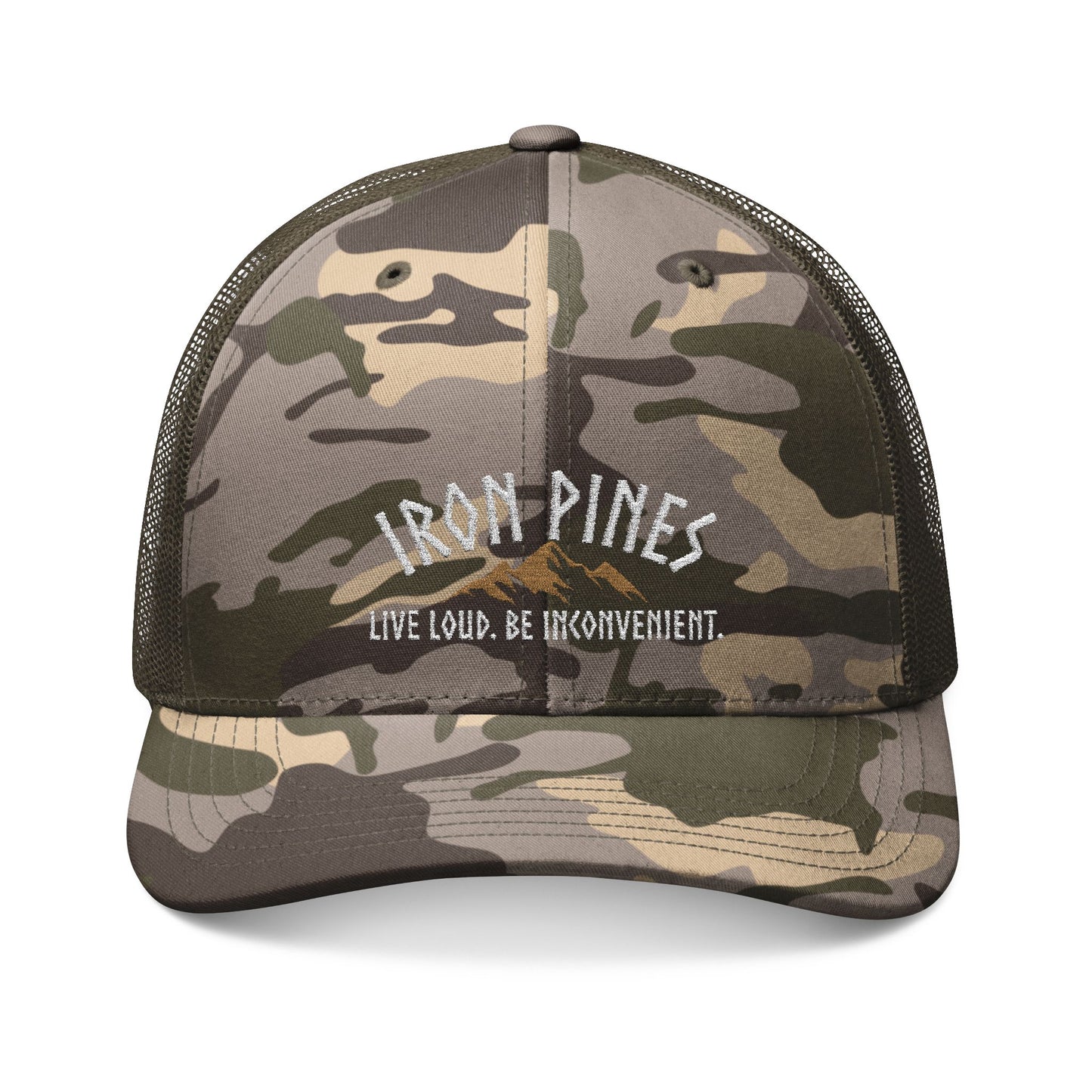 The Be Inconvenient Camo Trucker Hat by Iron Pines, available from Printify, features mesh backing, a snapback fit, embroidered Iron Pines above a mountain graphic, and the bold phrase Live Loud. Be Inconvenient.—perfect for adventurers.