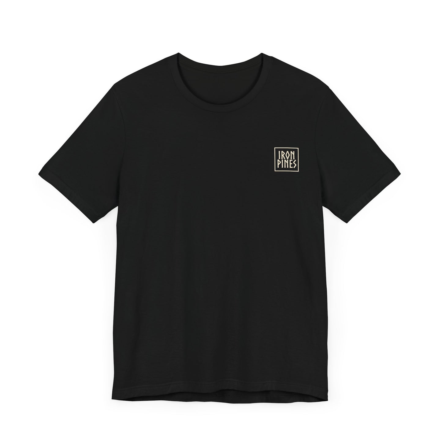 The Iron Pines Crest Tee by Printify features soft black Airlume cotton and a small, square white-and-gold IRON PINES logo on the upper left chest. Laid flat against a white background.