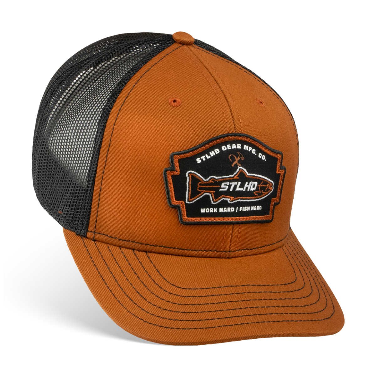 The STLHD GEAR Hook X Hammer Trucker Hat has a brown and black color scheme, breathable mesh back, adjustable snapback, and features a front patch with STLHD GEAR MFG CO. WORK HARD / FISH HARD and a fish graphic with crossed fishing rods.