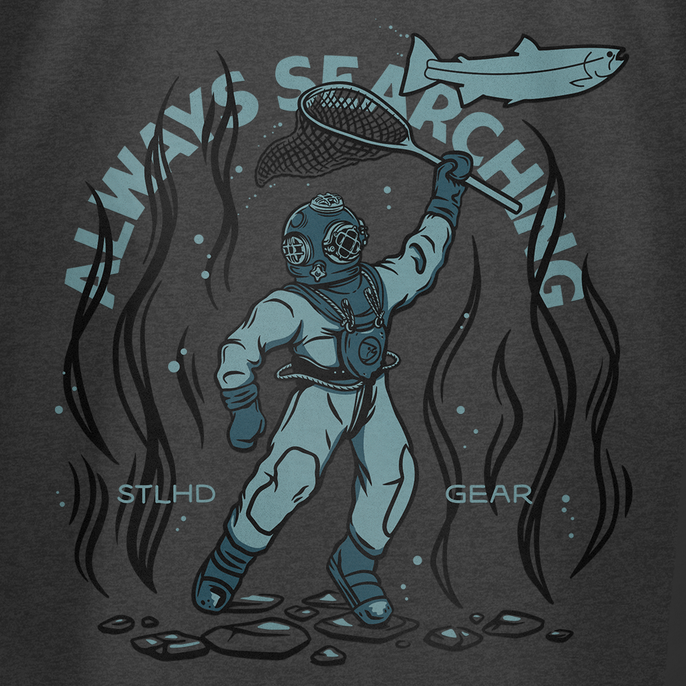 Illustration of a vintage deep-sea diver holding a net toward a fish, with seaweed and rocks. Embrace adventure in the STLHD Men’s Deep Dive T-Shirt by STLHD GEAR—“ALWAYS SEARCHING” and brand name appear in the background.