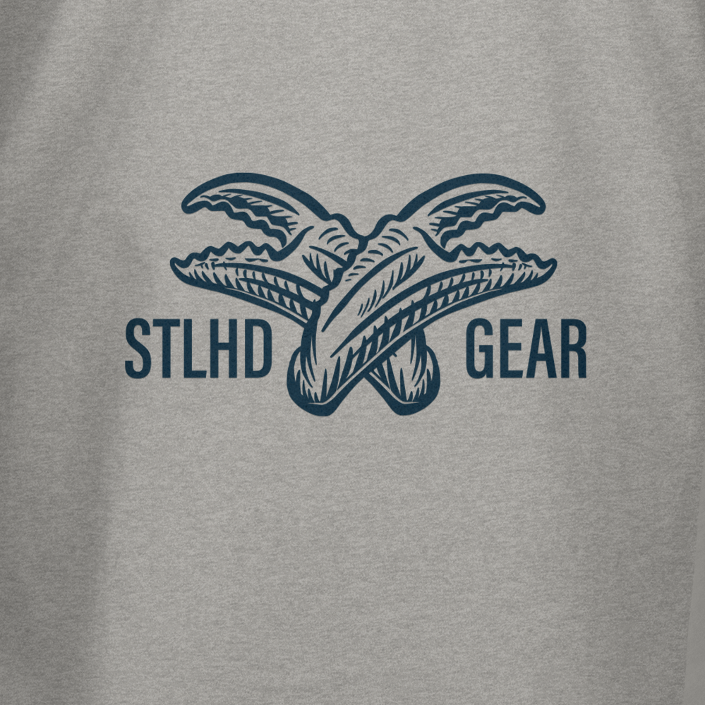 The STLHD Mens Crabby T-Shirt by STLHD GEAR features two overlapping fish tails and bold branding on a gray background, perfect for anglers seeking breathable comfort.