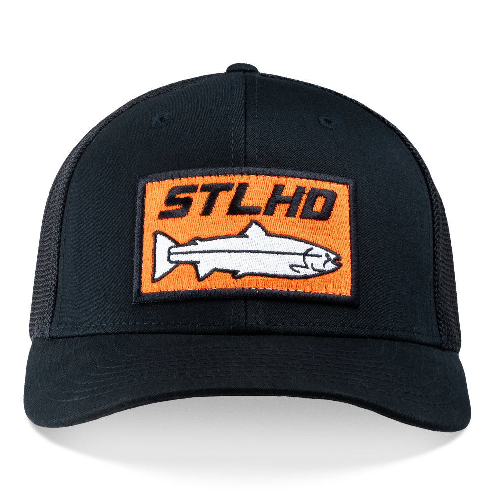 The STLHD Beaver State Flex Fit Trucker by STLHD GEAR is a black mesh-back hat with an orange rectangular front patch displaying STLHD Beaver State above a white fish graphic.
