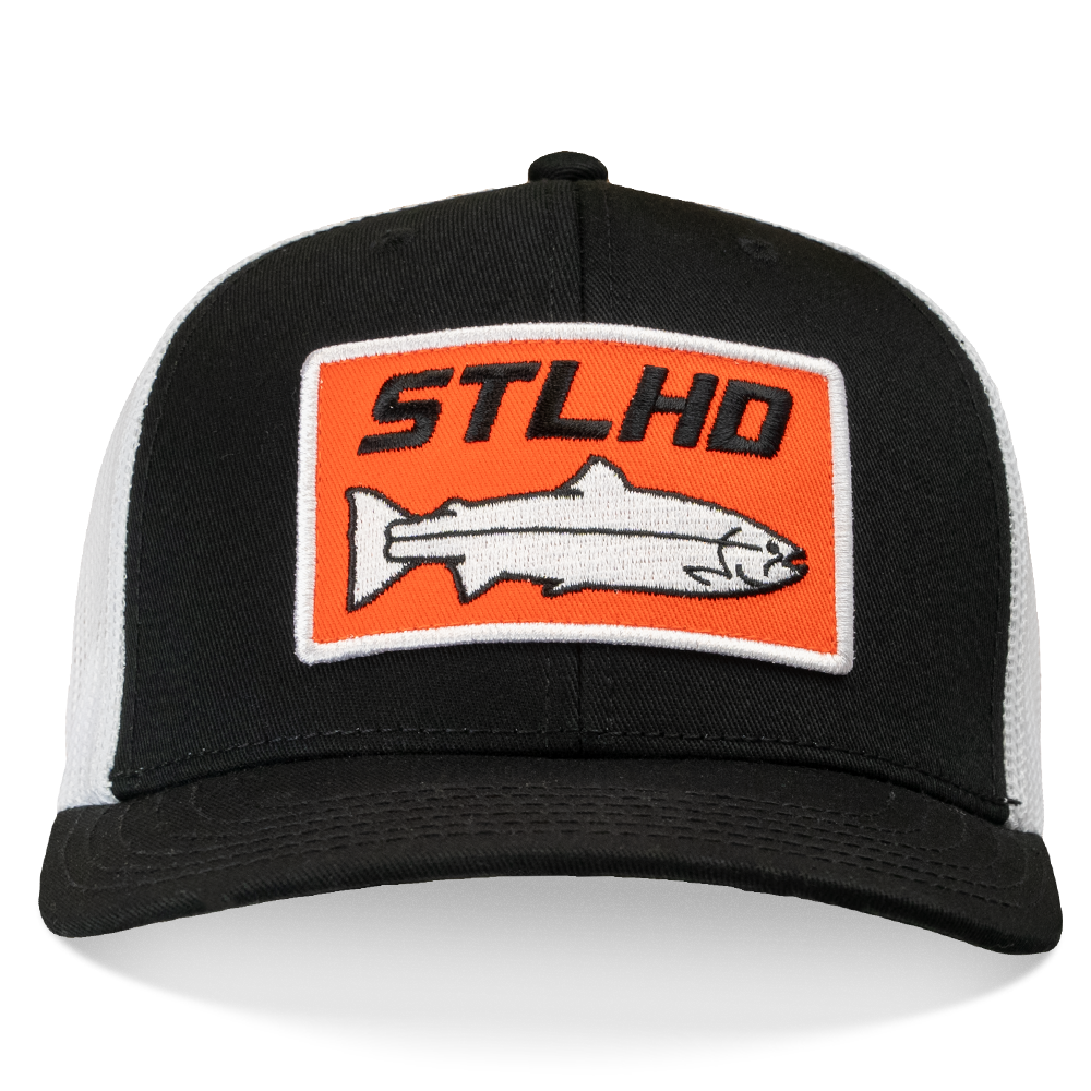 The STLHD Standard White & Black Trucker Hat by STLHD GEAR features an orange patch with STLHD text and a white fish graphic on the front, plus an adjustable snapback for comfort.