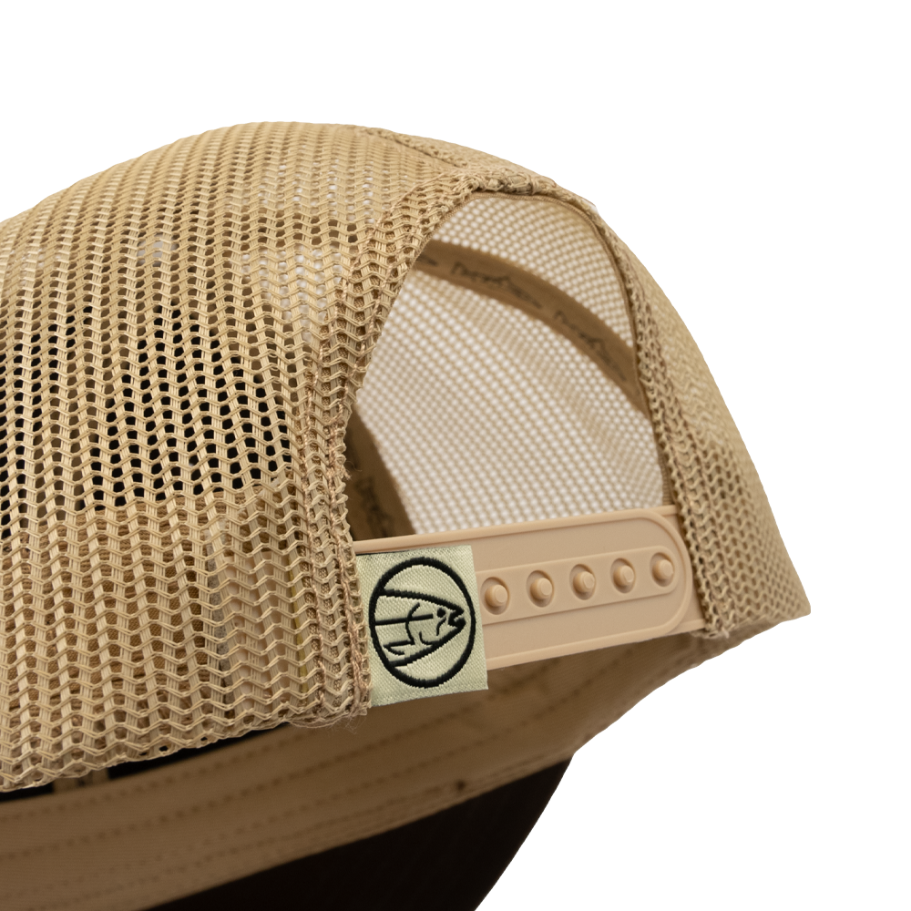A close-up of the back of the STLHD GEAR Steelhide Brown/Khaki Hat, featuring beige mesh, an adjustable snapback closure, and a small fabric tag with a black basketball logo.