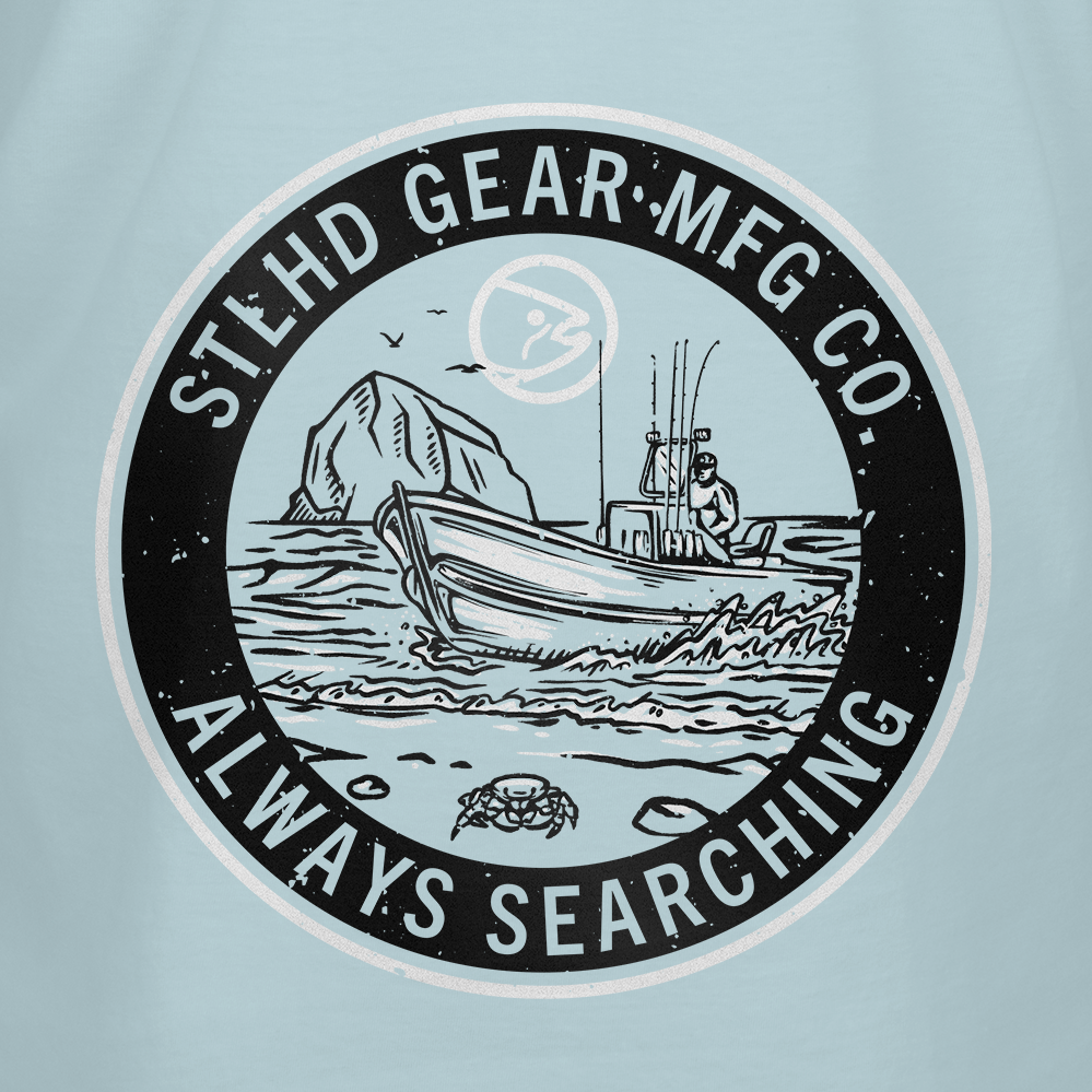 A circular logo shows a person fishing by a large rock, birds flying overhead, and a crab on the shore. The text says: STLHD GEAR ALWAYS SEARCHING—ideal for any outdoorsman or the STLHD Coastie T-Shirt by STLHD GEAR.