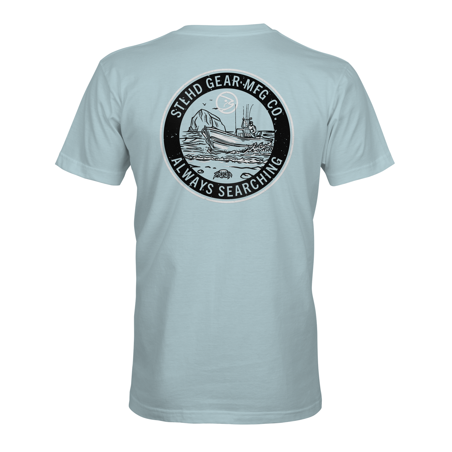 The STLHD Coastie T-Shirt by STLHD GEAR features a light blue design with a circular ship-at-sea graphic and STLHD GEAR MFG CO. ALWAYS SEARCHING text—ideal breathable comfort for any outdoorsmans collection.