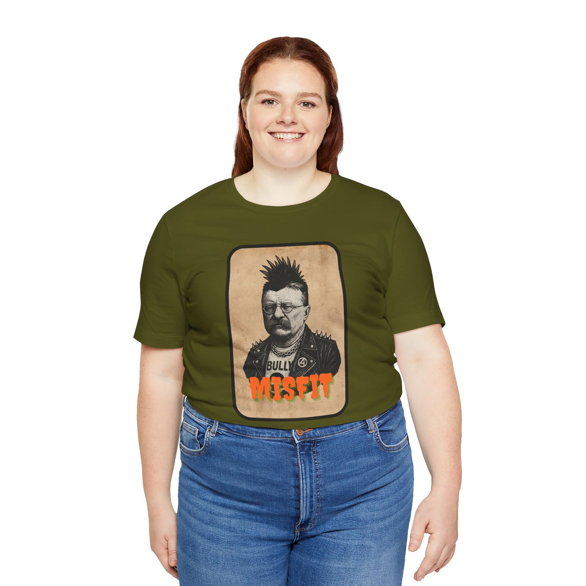 A woman with long reddish-brown hair wears Iron Pines Teddy Roosevelt Punk T-Shirt—Misfit History Tee for Rebels, Patriots & Wild Hearts—in green with blue jeans.