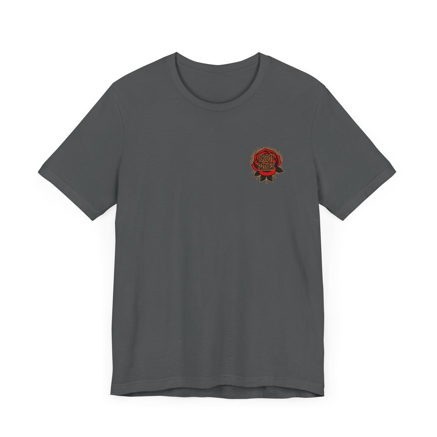 The Never Mistake My Kindness For Weakness Tee by Printify is a unisex dark gray shirt with a small, circular red and gold emblem plus decorative text and graphics on the left chest.