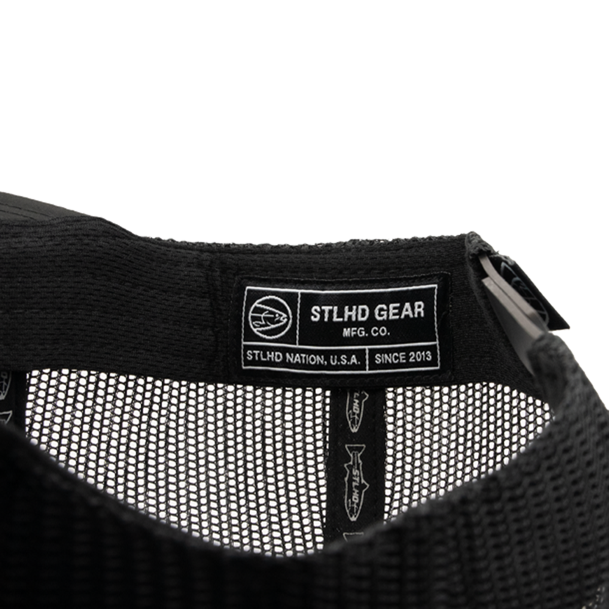 Close-up of the STLHD Chrome Performance Flat Bill Hats black mesh interior, featuring an STLHD GEAR fabric label with STLHD NATION, U.S.A. SINCE 2013, a circular fish logo, and an adjustable snapback.
