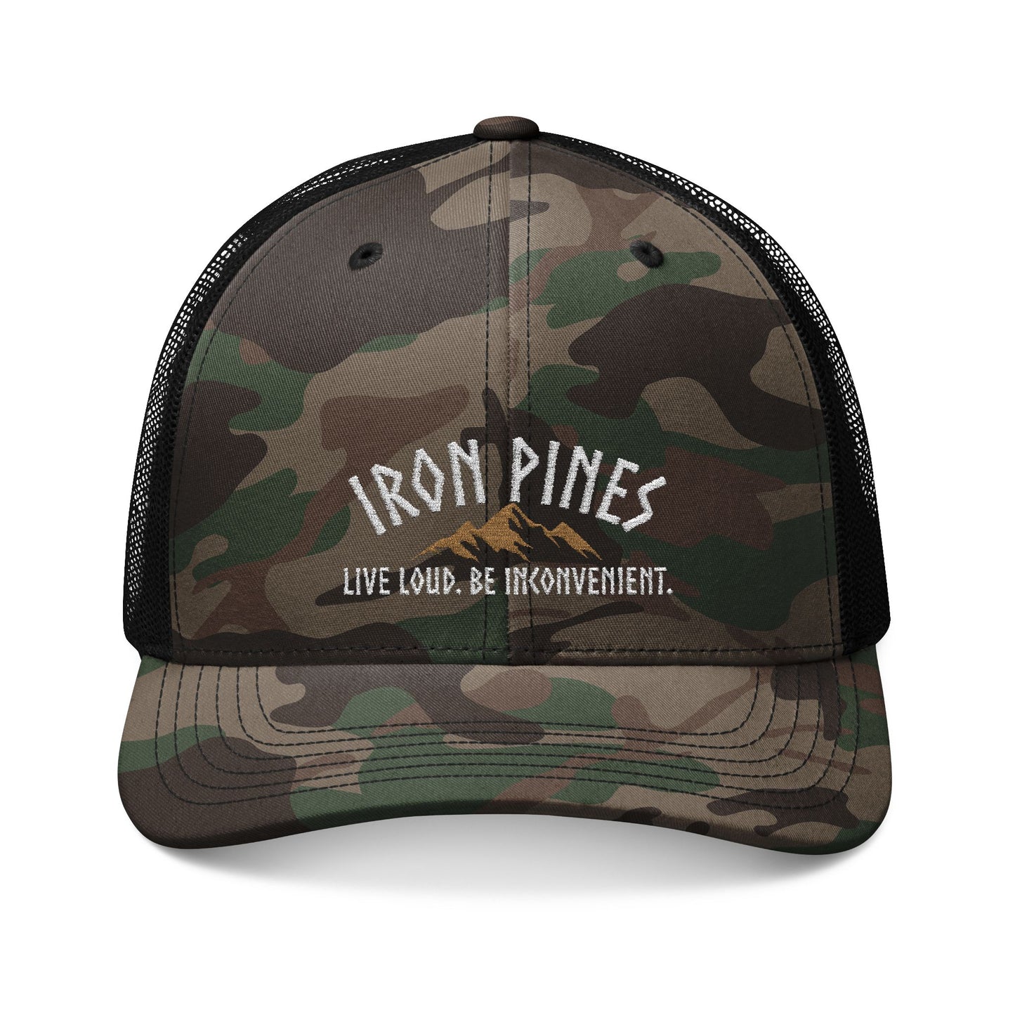 The Be Inconvenient Camo Trucker Hat by Iron Pines features a camo pattern, black mesh back, IRON PINES above a gold mountain graphic, and LIVE LOUD. BE INCONVENIENT. Perfect snapback for outdoor adventures. Brand: Printify.