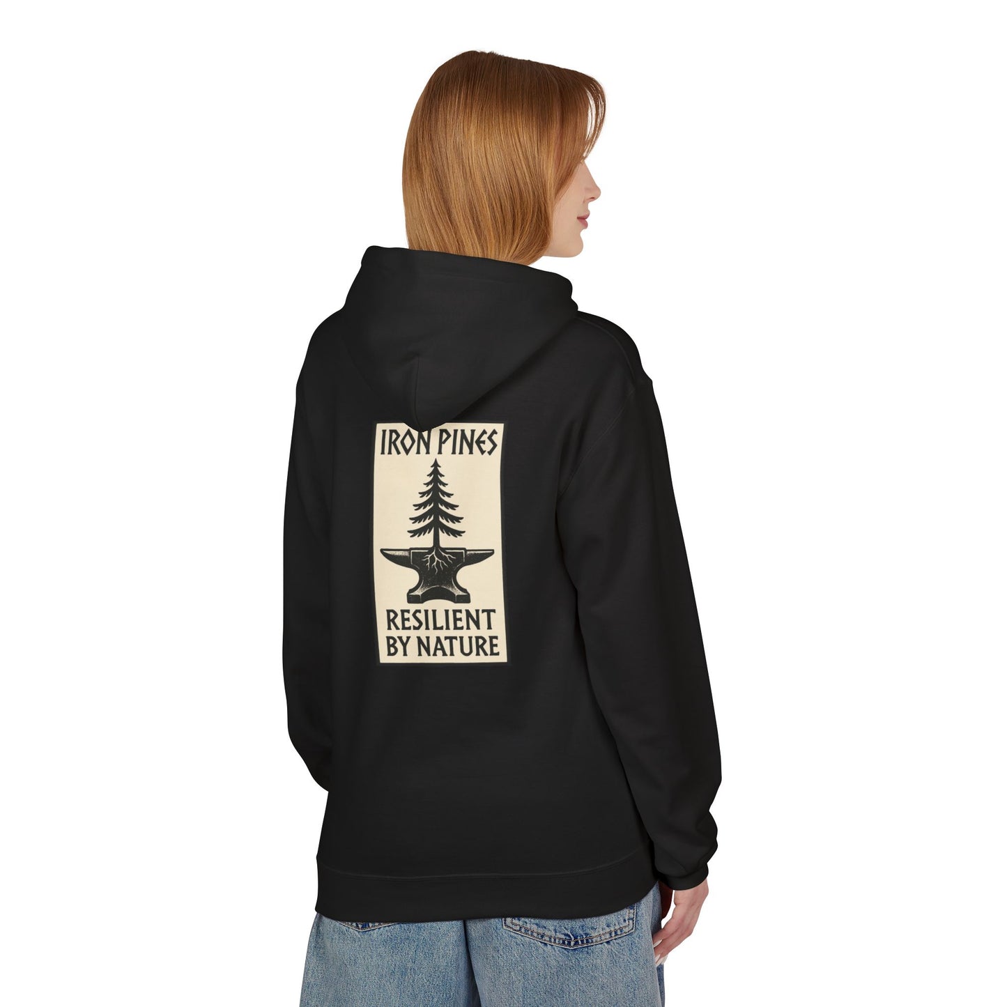 A person with straight, light brown hair, facing away from the camera, wears The Iron Pines Hoodie by Printify—a midweight fleece hoodie with a tree above an anvil and “IRON PINES RESILIENT BY NATURE” on the back.