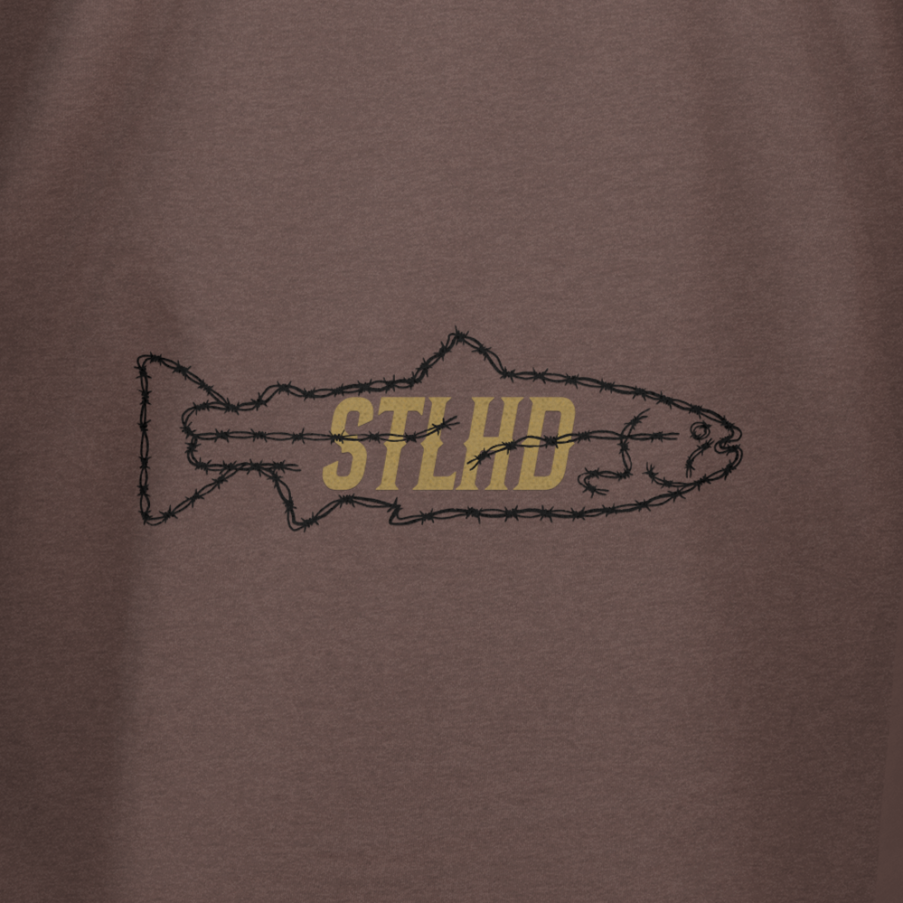 The STLHD Rancher T-Shirt by STLHD GEAR features a barbed wire fish outline with bold, gold “STLHD” text on a brown background—an ideal pick for fishing or ranch life.