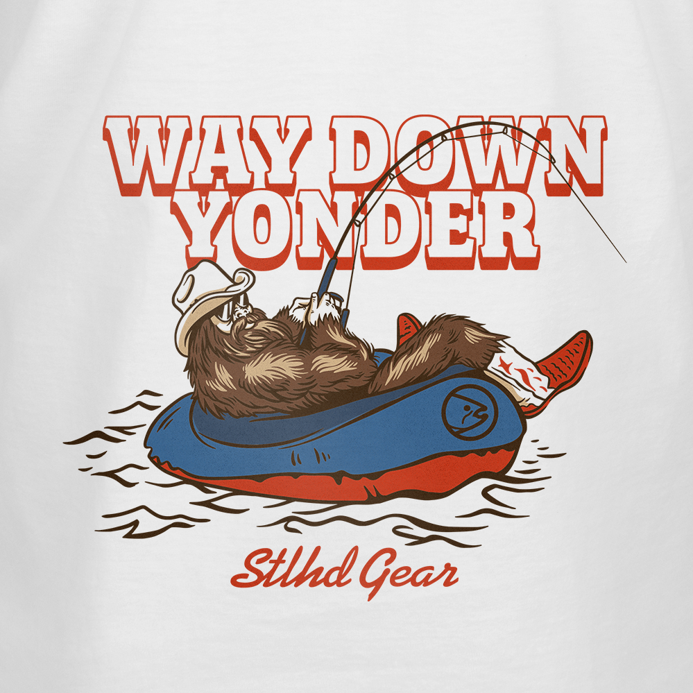 A graphic featuring  Way down yonder STLHD GEAR text and an image of bigfoot with cowboy boots and hat fishing from a raft in a body of water.
