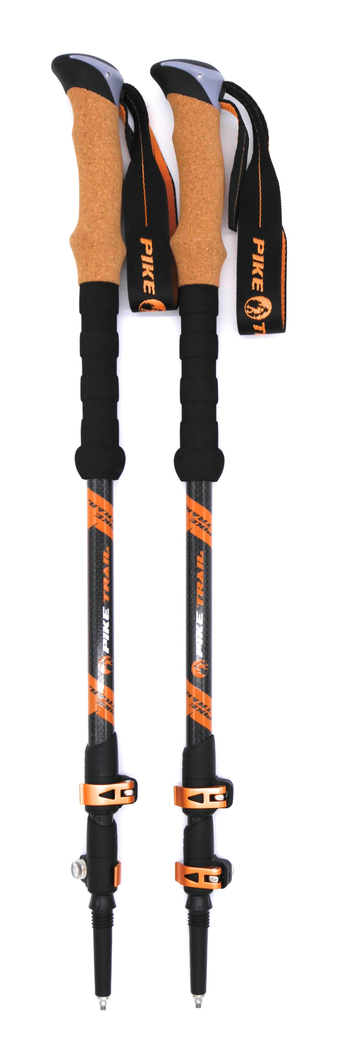 Two Pike Trail Carbon Fiber Trekking Poles in black and orange, featuring cork handles, foam grips, wrist straps, and pointed tips, stand side by side against a white background. High-performance hiking sticks for trekking and walking.
