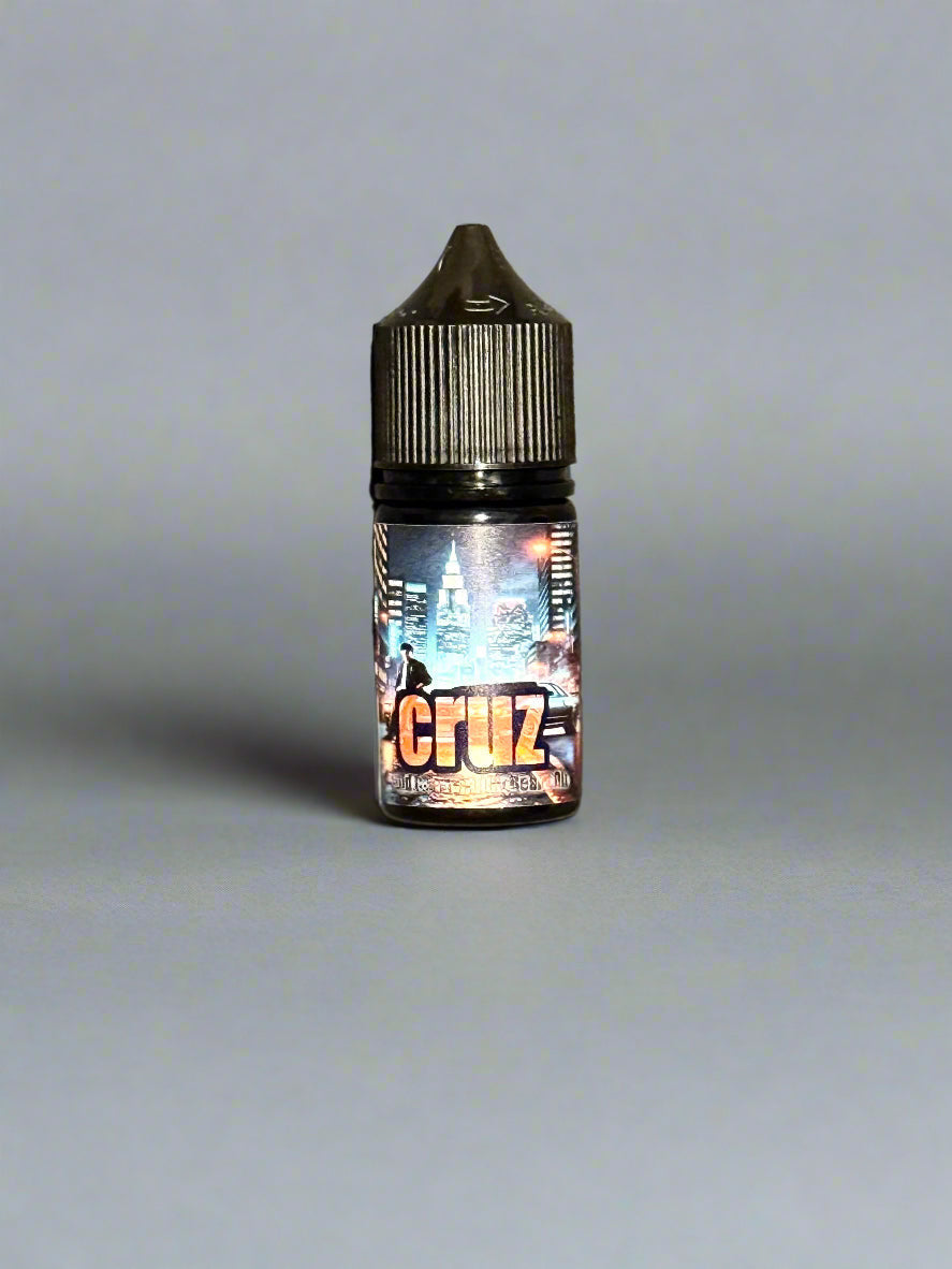 A small bottle of CRUZ Beard Oil & Balm by Bedlam Beard Company, with a dark cap and cityscape label, featuring musk notes, stands upright on a plain gray background.