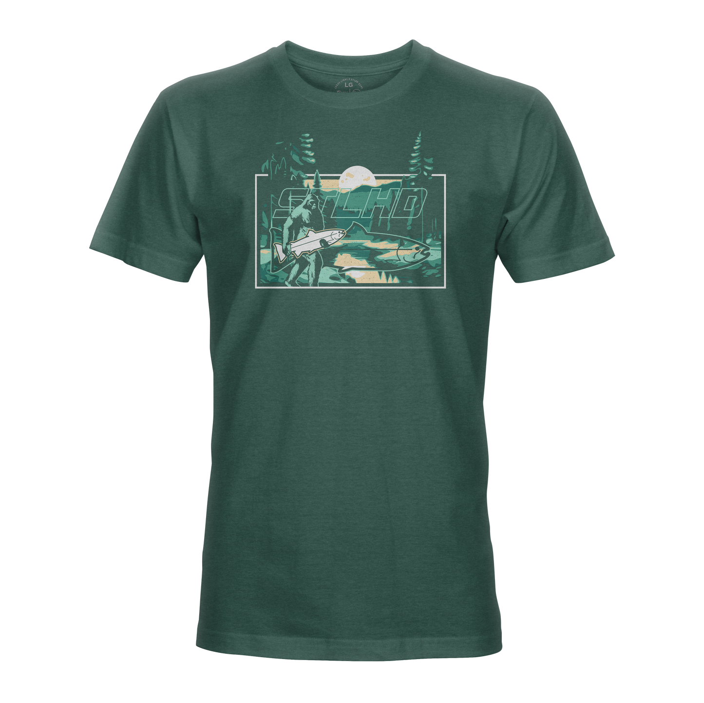 The STLHD Lost Forest T-Shirt by STLHD GEAR is a dark green outdoor tee with a mountain, trees, river, and angler scene. “Macho” stands out above the art—ideal for fans of outdoor adventure apparel.
