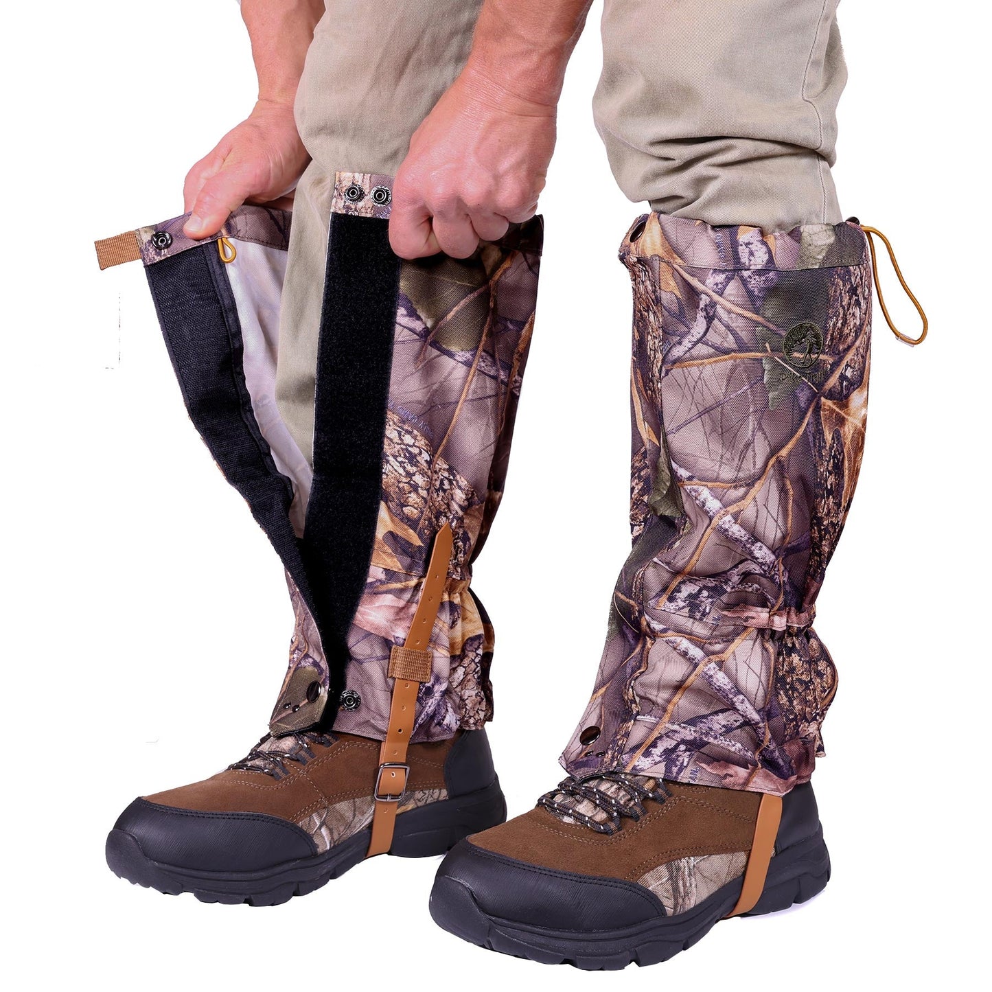 A person fastens Pike Trail All-Season Waterproof Leg Gaiters—built for the trail, the hunt, and everything in between—around their lower legs, securing them with Velcro and under-boot straps.