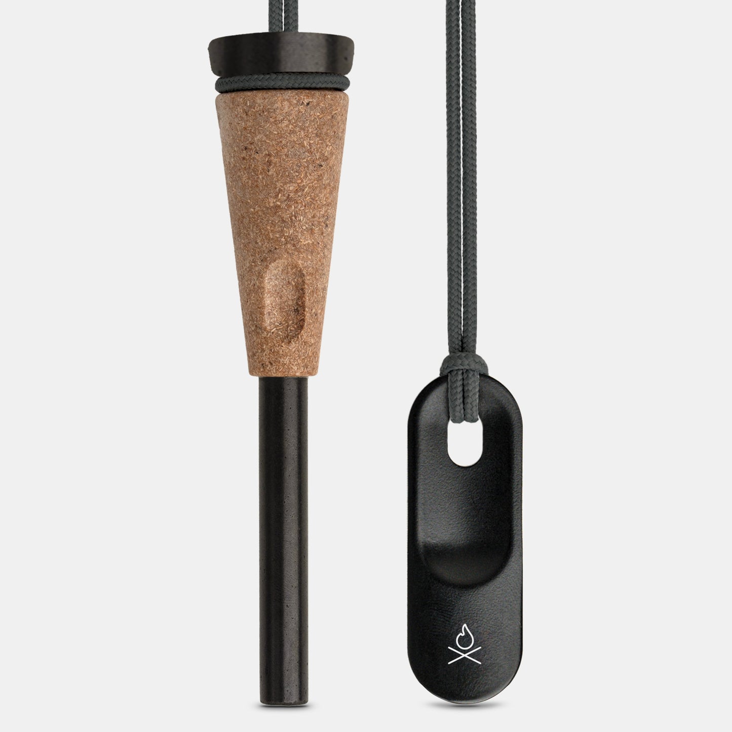 The Überleben Zünden PRO – Modern Flint & Steel Fire Starter by Überleben features a black cylindrical ferro rod with a wood-composite handle and a black striker on a gray cord, both upright on a light gray background.