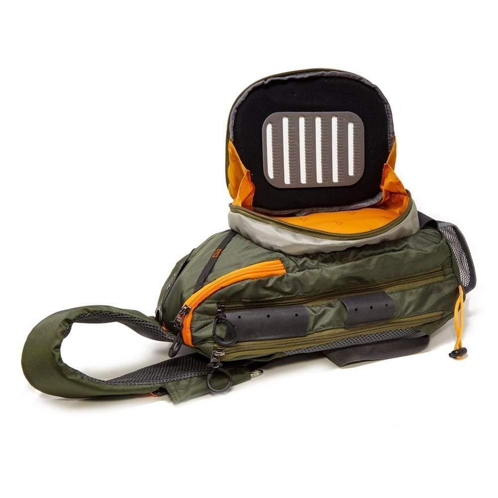 The Jackson Hole Fly Company JHFLYCO 13L Adjustable Sling Pack is shown open in green and orange, featuring a single strap and a padded interior with vertical white slots for organizing or protecting electronic devices.