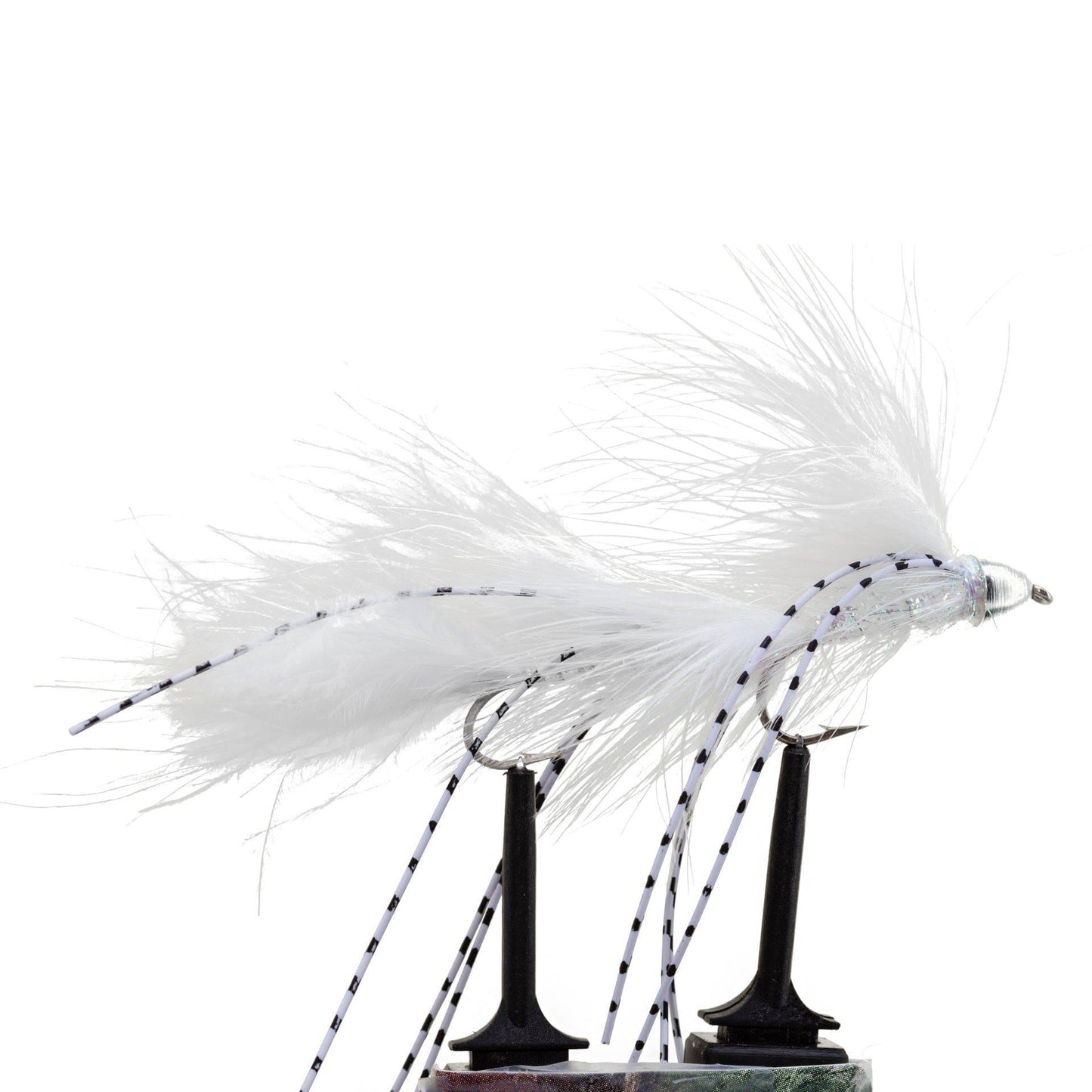 A close-up of the Jackson Hole Fly Company JHFLYCO Loaded Foam Fly Box – Large Streamer Assortment (10 Flies), featuring detailed white artificial flies, ideal for predator fly fishing, displayed on black stands against a white background.