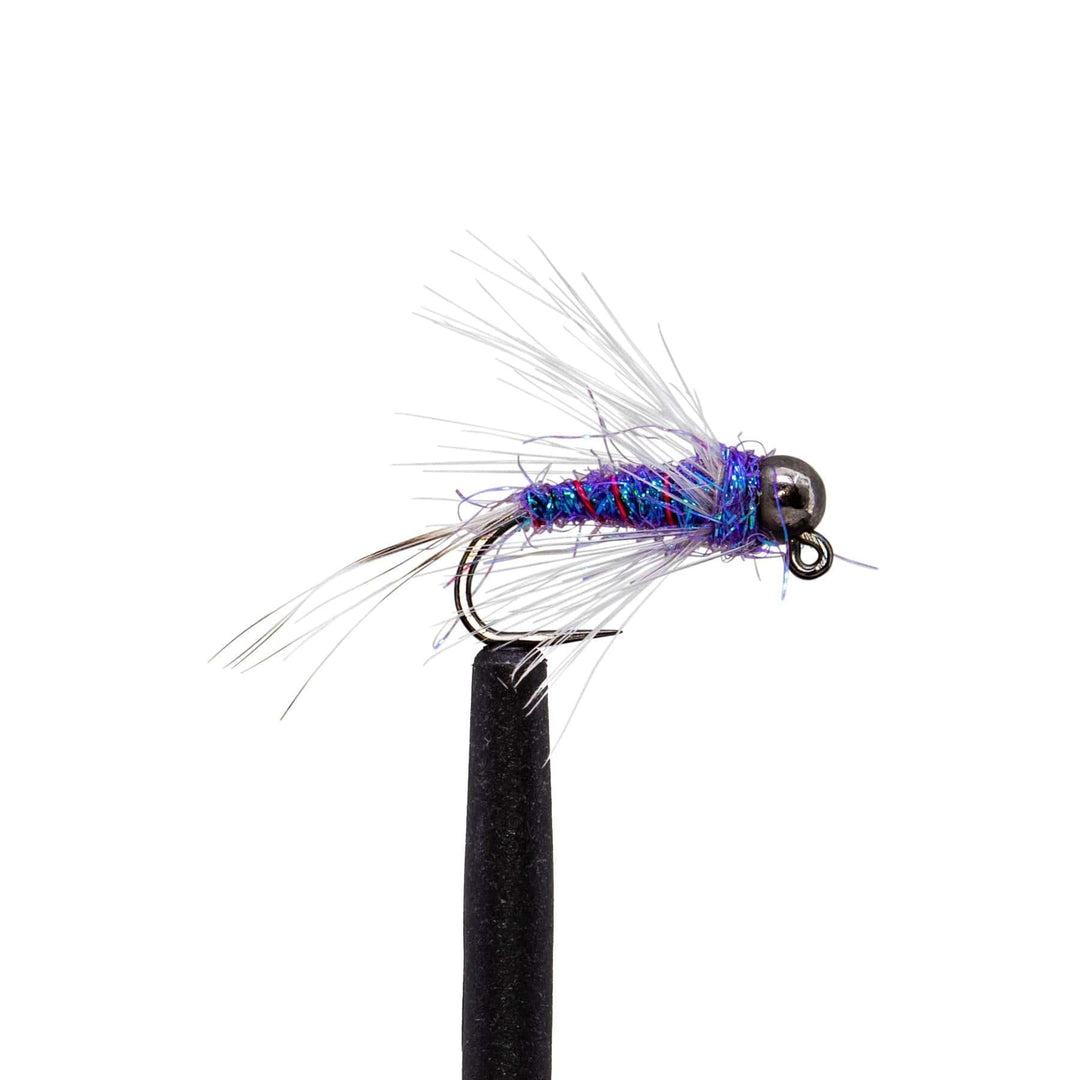 A vibrant Euro jig nymph from the Jackson Hole Fly Company’s JHFLYCO Loaded Foam Fly Box - Euro Nymph Assortment features a metallic bead head, blue-purple body, and white fibers, displayed on a black stand against a white background.