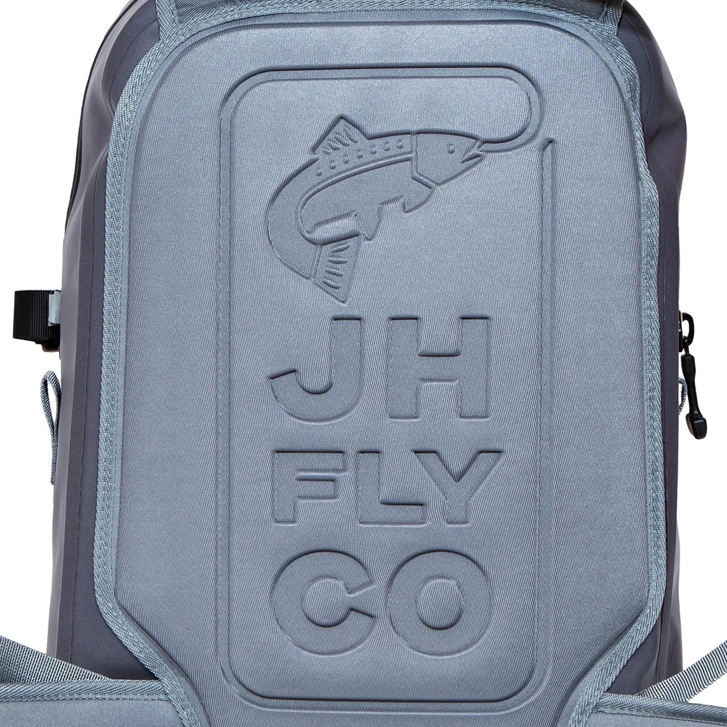 Close-up of the JHFLYCO 27L Waterproof Backpack by Jackson Hole Fly Company, made from gray 500D PVC with an embossed fish design, JH FLY CO on the front, and a rugged TIZIP zipper on the right side. Ready for the Wild.