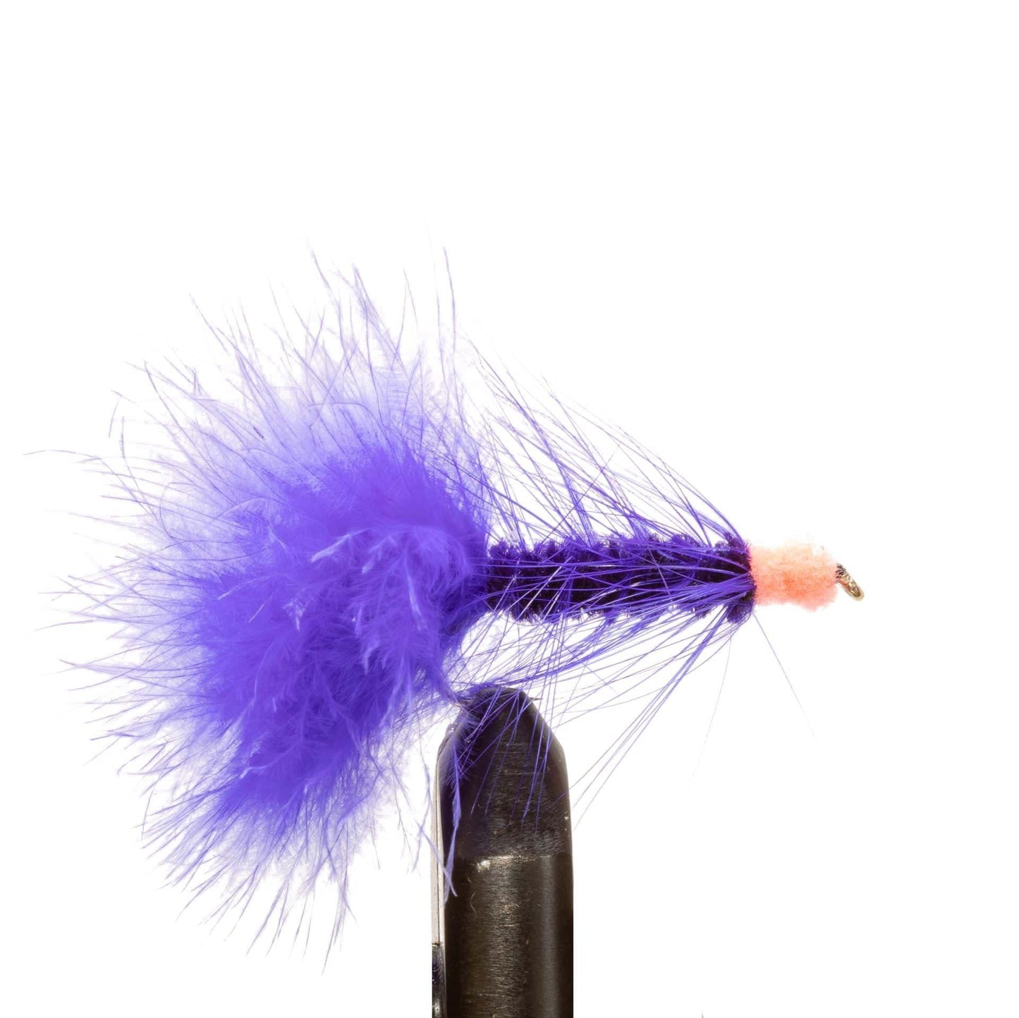 A close-up of a Jackson Hole Fly Company JHFLYCO Steelhead Fly Box lure—a premium spey fly with a purple feather tail and orange tip—part of the 24-piece collection, held by a black vise against a white background.