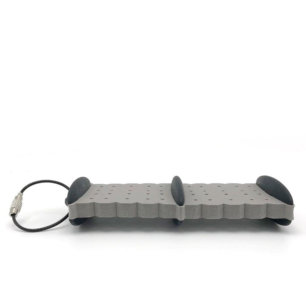 The Jackson Hole Fly Company Smith Creek Rig Keeper is a rectangular gray board with wavy grooves, three rounded black grips, and a wire loop—perfect for organizing and storing your fly fishing setups.