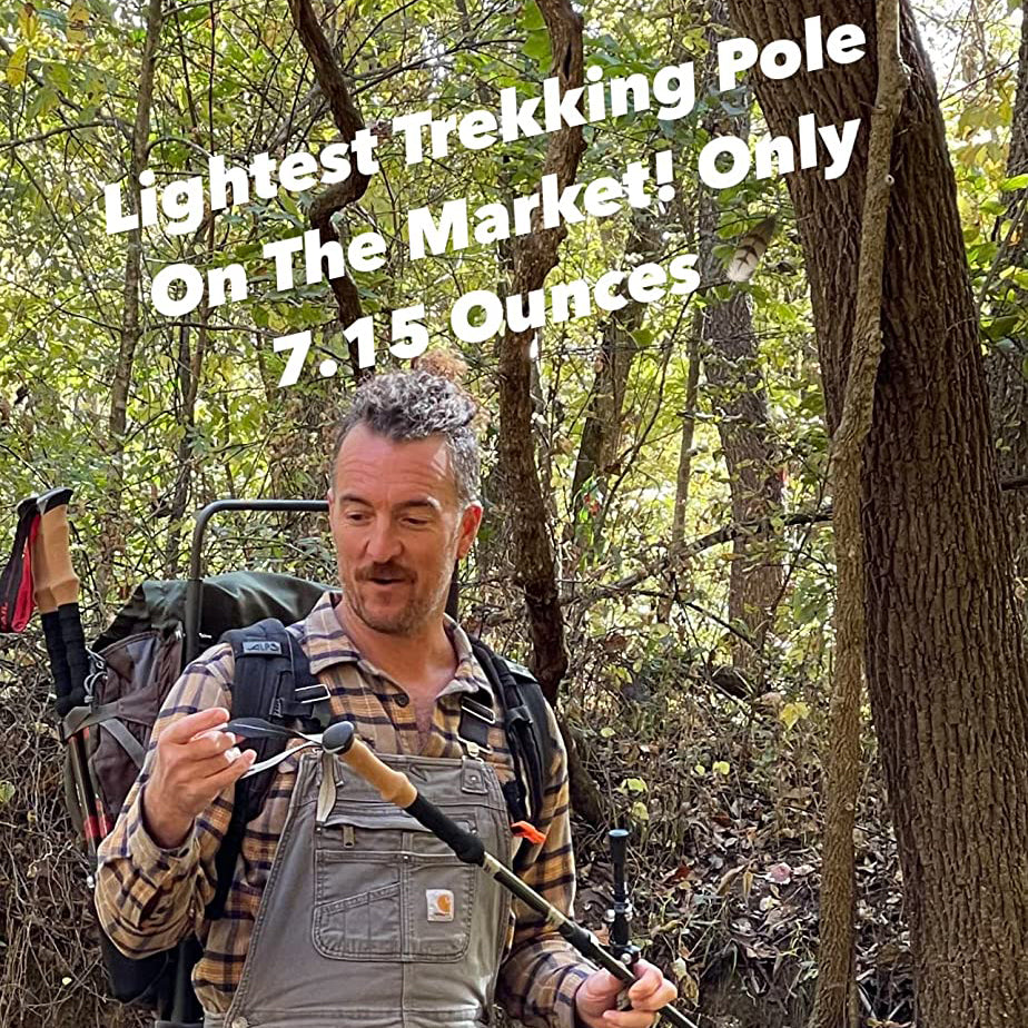 In a forest, a man in a plaid shirt smiles at his Pike Trail Carbon Fiber Trekking Pole—high performance hiking stick for trekking, hunting, and walking. He wears a backpack. Text above: “Lightest Pole On The Market! Only 7.15 Ounces.”.