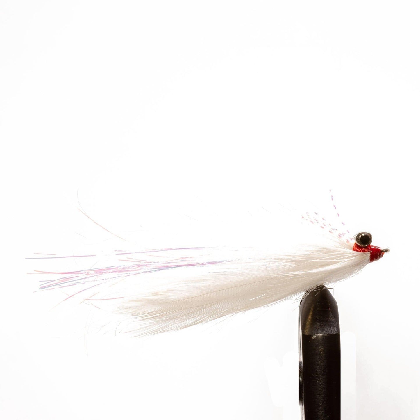A close-up of the Jackson Hole Fly Company JHFLYCO Snook Fly Box’s preloaded, strike-triggering white fly with red head and pink accents, saltwater-ready and held in a vise against a plain white background.