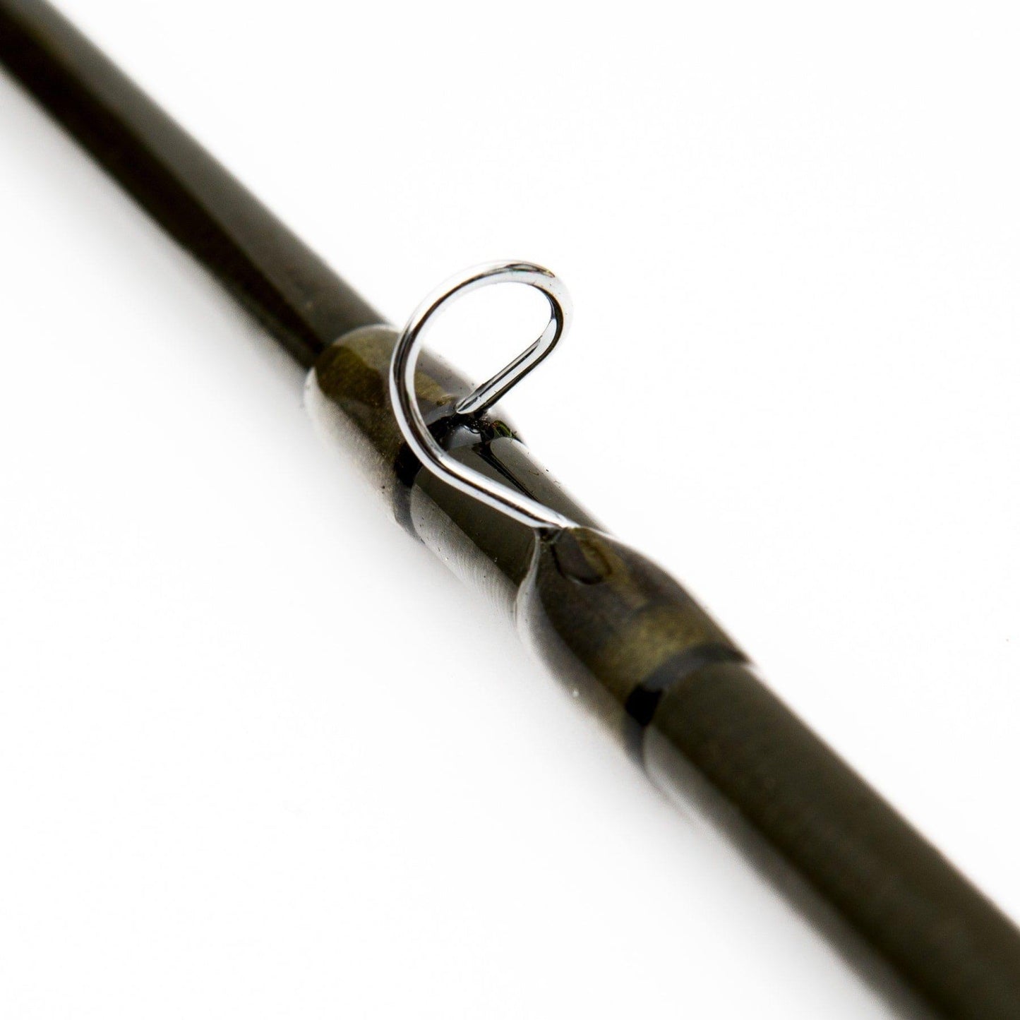 Close-up of the Jackson Hole Fly Company Yellowstone II Fly Rod - 4 Piece, Fast Action (3WT–7WT, 70–90) guide, with a metal loop on the IM8 graphite rod for fishing line, shown against a plain white background.