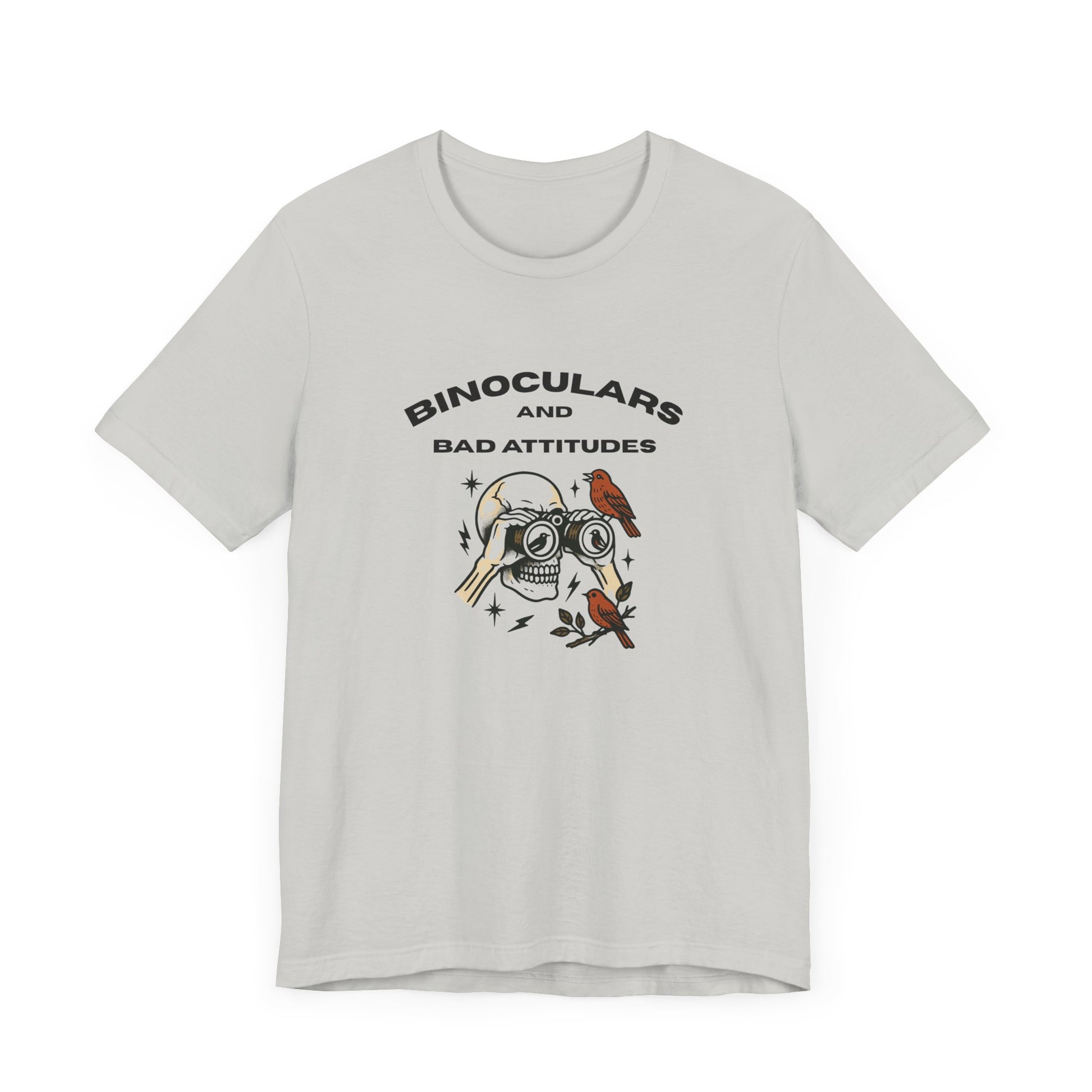 The Bird Watching Is Hardcore T-Shirt by Printify is a funny punk birder shirt for misfits and field freaks, featuring a skull with binocular eyes, birds, and sparks—perfect for edgy ornithologists. “BINOCULARS AND BAD ATTITUDES” tops the design.