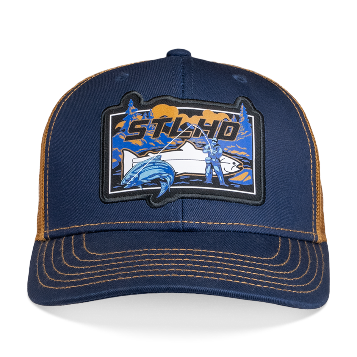 The STLHD GEAR Let’er Rip Trucker Hat features an adjustable snapback in navy blue and brown with a fisherman patch, mountain scenery, and bold STLHD lettering—ideal for any outdoor adventure.