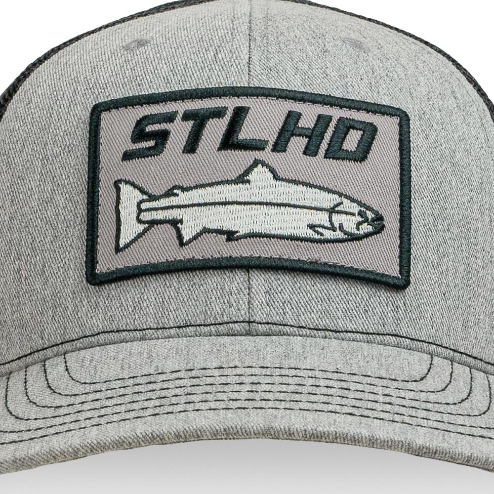 The STLHD GEAR Chrome Edition Heather Grey/Black Trucker Snapback Hat features a stitched patch with STLHD above an embroidered fish, plus an adjustable snapback for comfort and style.