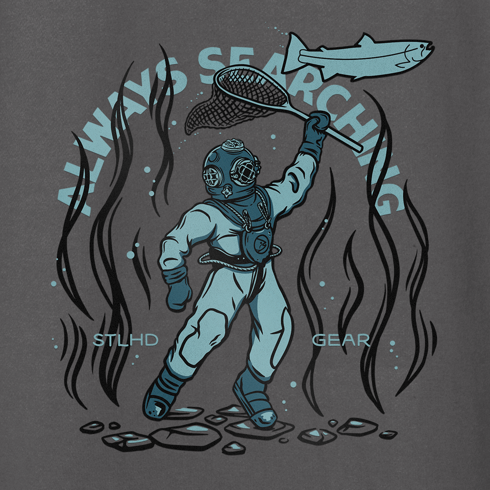 A vintage deep-sea diver catches a fish amid seaweed and rocks, with “ALWAYS SEARCHING” above and “STLHD GEAR” below—the STLHD Men’s Deep Dive Premium Hoodie is perfect for outdoor adventurers.