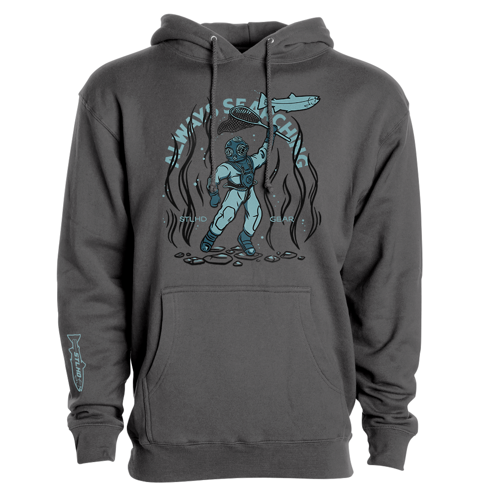 The STLHD GEAR Men’s Deep Dive Premium Hoodie in dark gray features a blue diver with a surfboard underwater, surrounded by seaweed and stones, plus “WAVY SEARCHIN” above and “MIND CLEAR” on the sides for an outdoor adventure vibe.