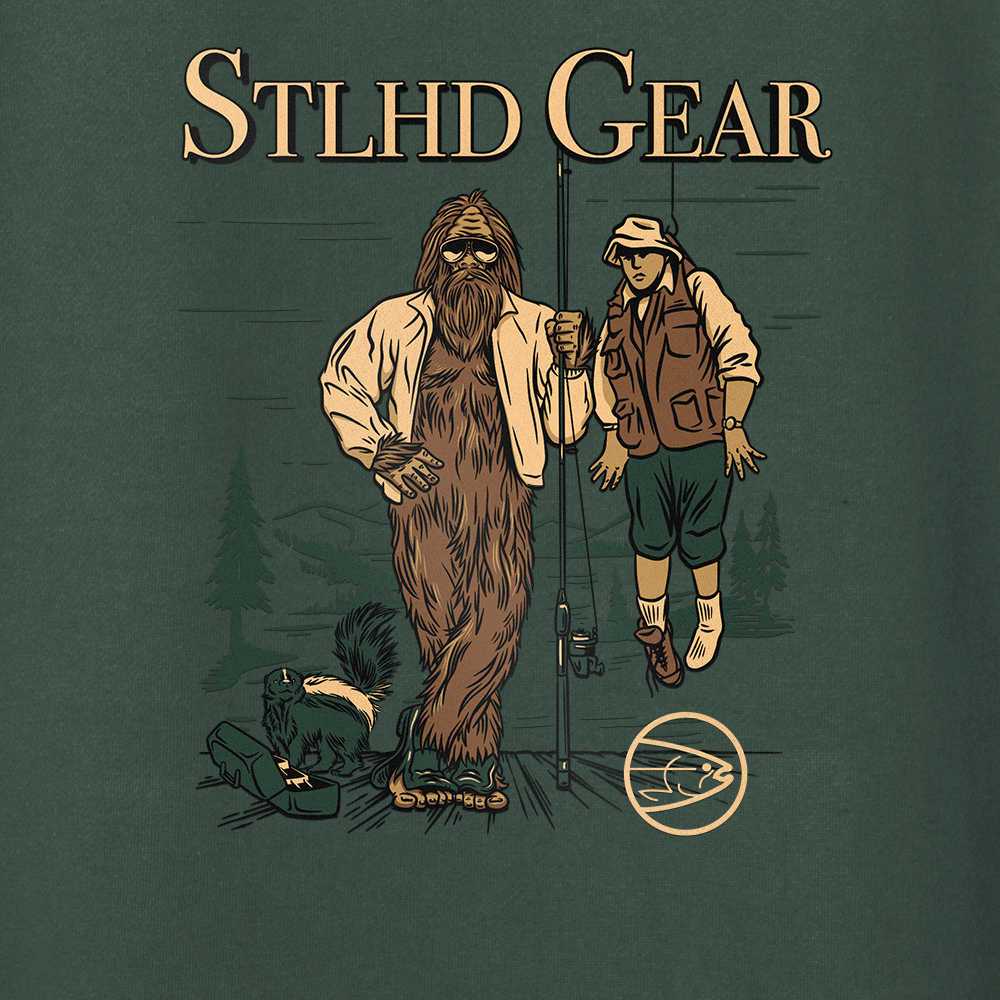 Illustration of Bigfoot holding up a man with a fishing rod, with STLHD GEAR TEXT across the top branding on a green background