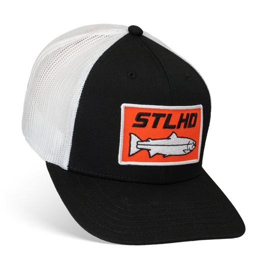 The STLHD GEAR Standard White & Black Trucker Hat features a mesh back, adjustable snapback, and a front patch with an orange rectangle, fish graphic, and STLHD text.