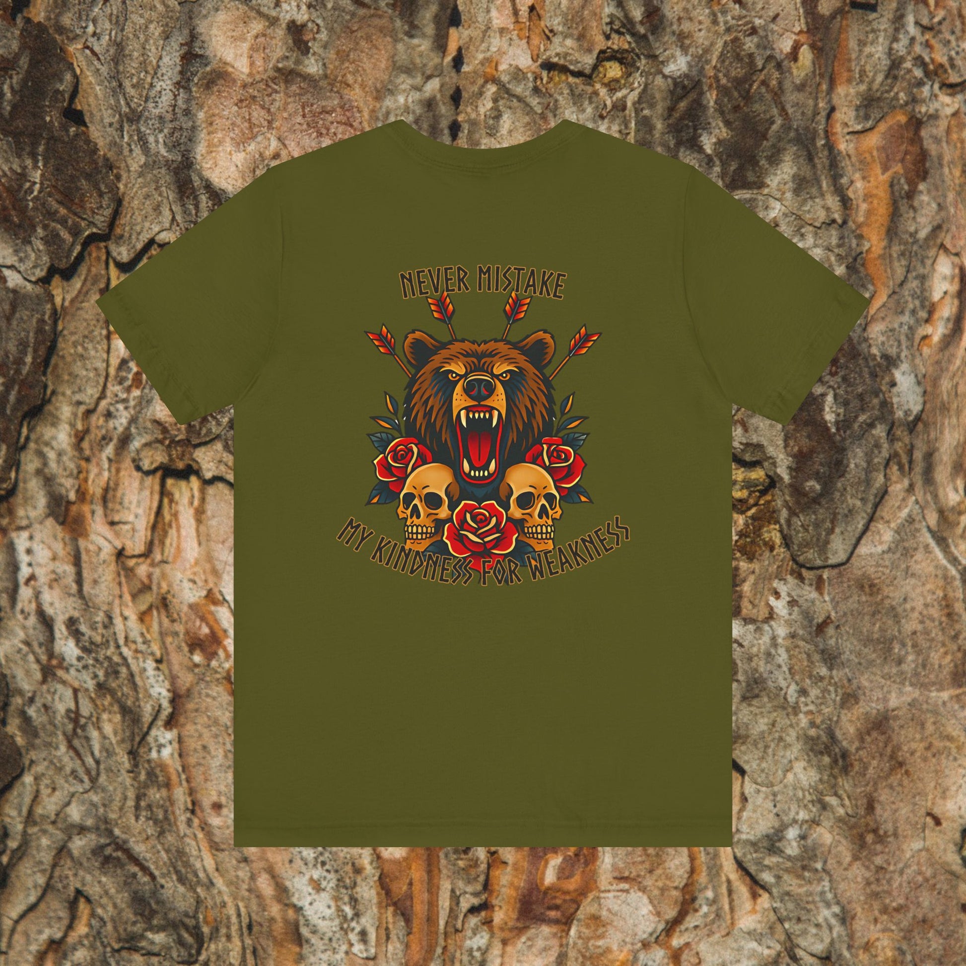 The Never Mistake My Kindness For Weakness Tee by Printify features a roaring bear, red roses, skulls, arrows, and bold text on an Airlume cotton unisex shirt with a tree bark background.