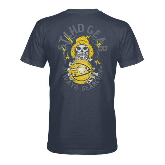 Navy blue t-shirt with a graphic design on the back featuring a skull in a fisherman's hat and STLHD GEAR ALWAYS SEARCHING text, on a white background.