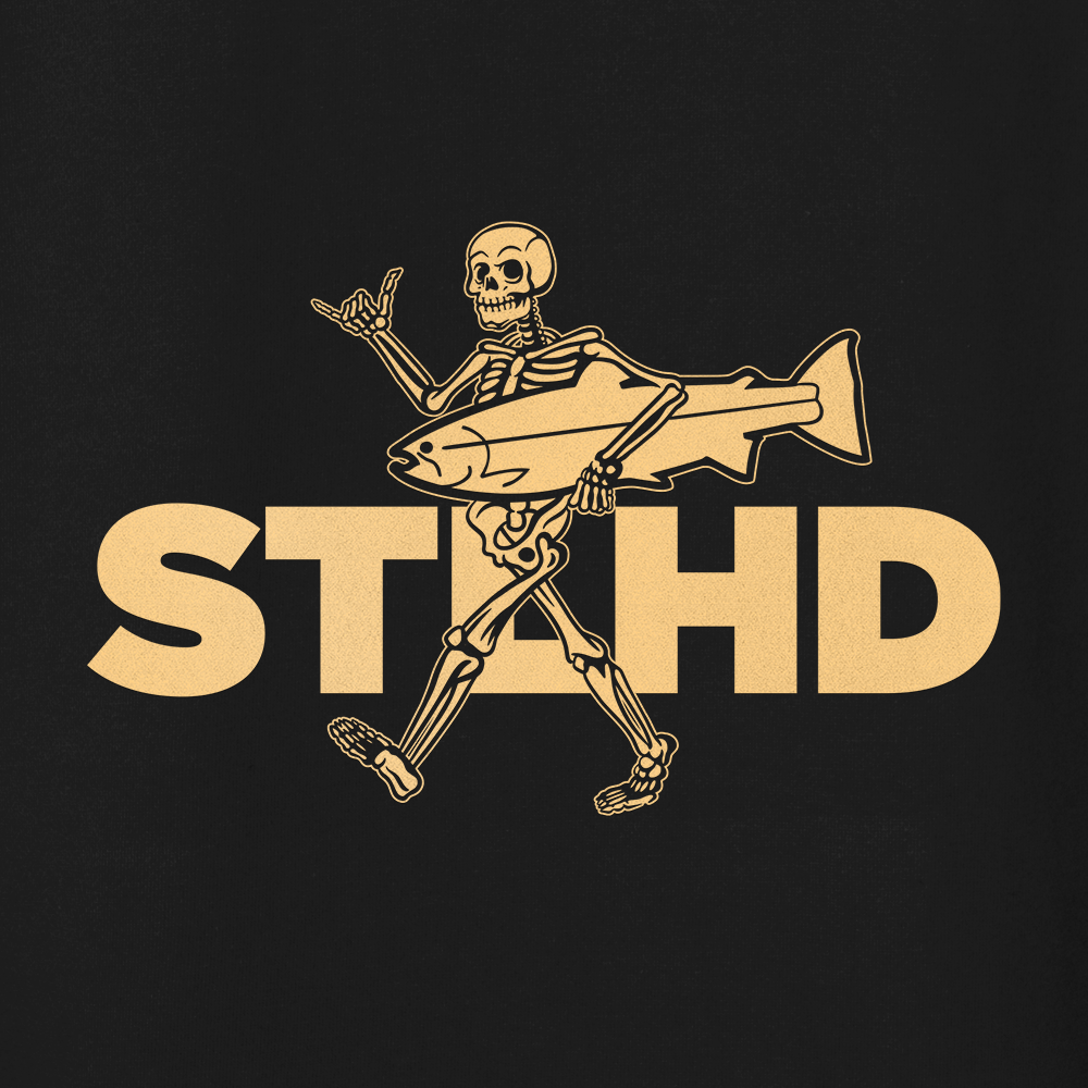 The STLHD Loosey Goosey Premium Hoodie by STLHD GEAR features a cartoon skeleton with a fish and shaka sign in front of bold STLHD letters—an ultra-soft fleece hoodie with standout style on black.