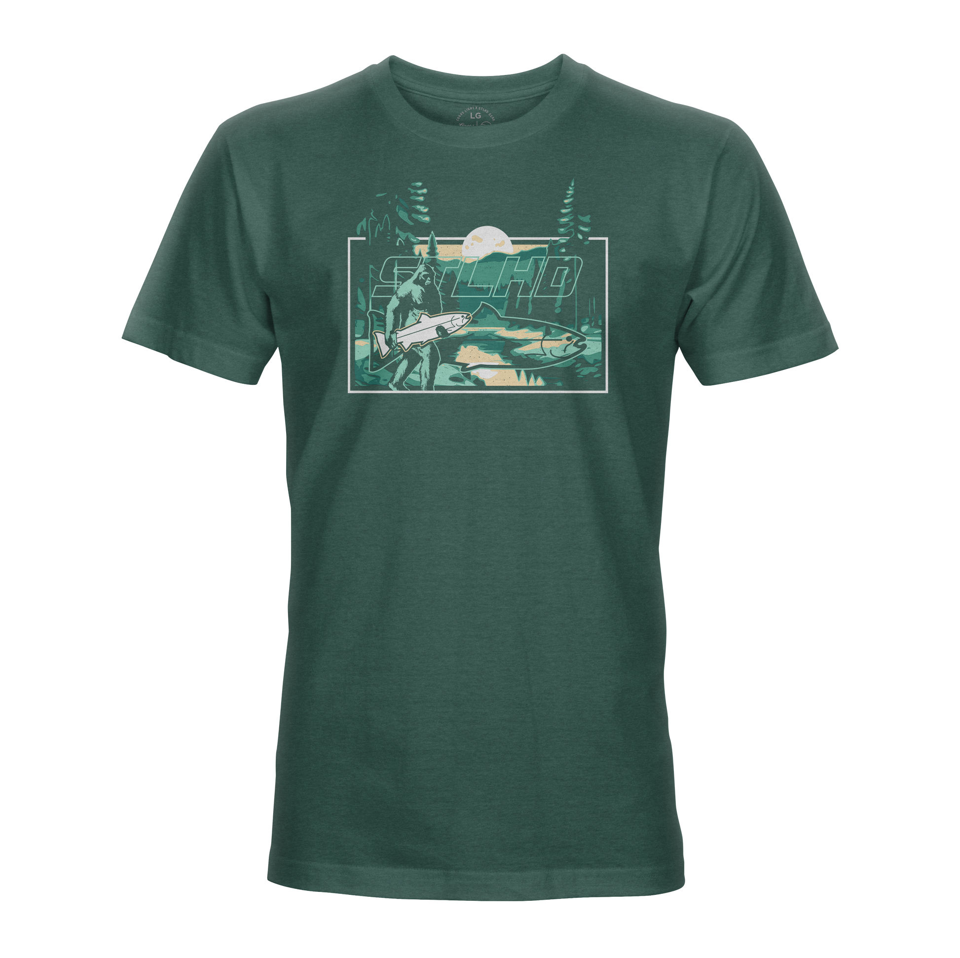 The STLHD Lost Forest T-Shirt by STLHD GEAR is a dark green outdoor tee with a mountain, trees, river, and angler scene. “Macho” stands out above the art—ideal for fans of outdoor adventure apparel.