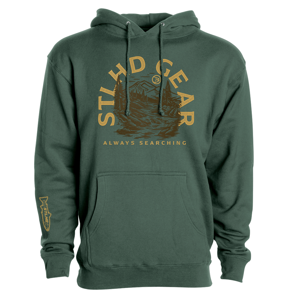 The STLHD GEAR Mountain View Premium Hoodie is a durable outdoor hoodie with yellow lettering above a mountain and river graphic, plus a fish illustration on the left sleeve.