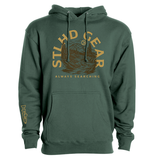 The STLHD GEAR Mountain View Premium Hoodie is a durable outdoor hoodie with yellow lettering above a mountain and river graphic, plus a fish illustration on the left sleeve.