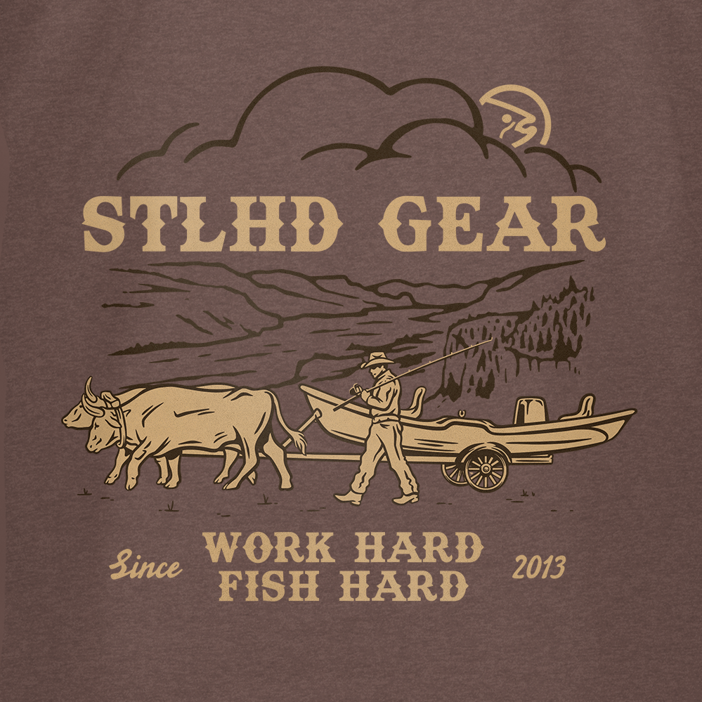 Illustration of a man pulling a boat with oxen before mountains and trees, plus STLHD GEAR, Work Hard Fish Hard, Since 2013. The STLHD Oregon Trail T-Shirt brings breathable comfort from STLHD GEAR for every adventure.