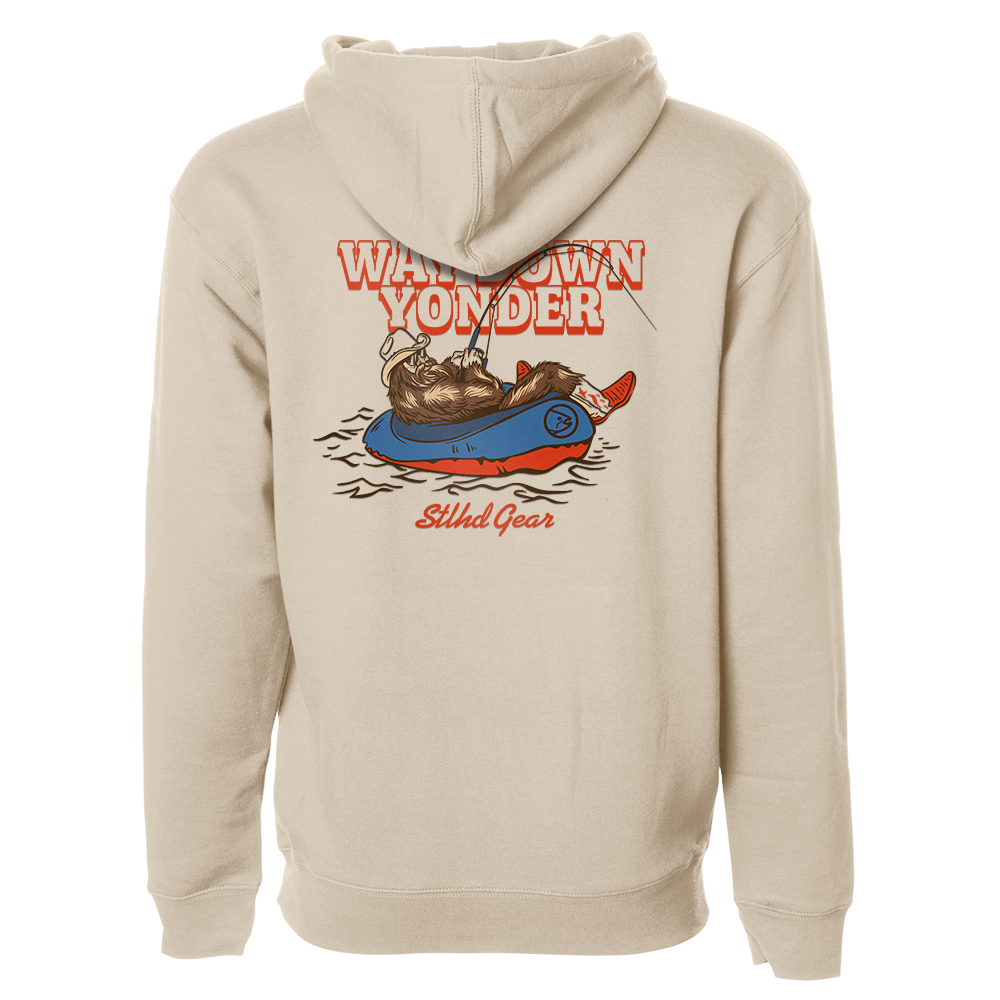 Beige hoodie with a graphic design on the back featuring  Way down yonder STLHD GEAR text and an image of bigfoot with cowboy boots and hat fishing from a raft in a body of water.