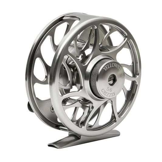 The Jackson Hole Fly Company Yellowstone Grizzly Fly Reel with Sealed Drag (Multiple Sizes & Colors) features CNC-machined aluminum, an open modern design, and “Yellowstone 5/6 Grizzly” engraved on the center knob.