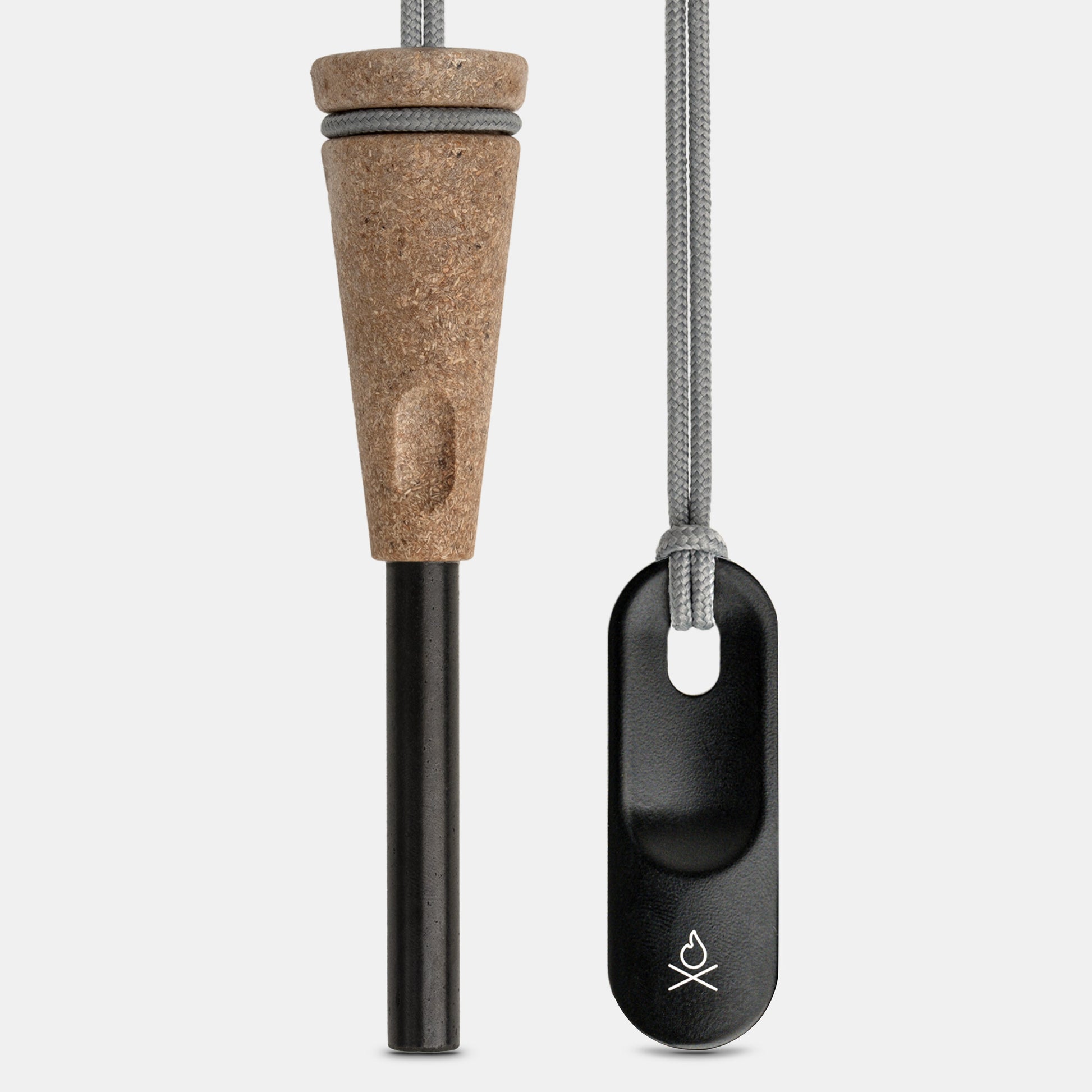 The Überleben Zünden PRO Modern Flint & Steel Fire Starter by Überleben features a wood-composite handle, black ferro rod, and black metal striker attached to a gray cord, all shown on a plain white background.