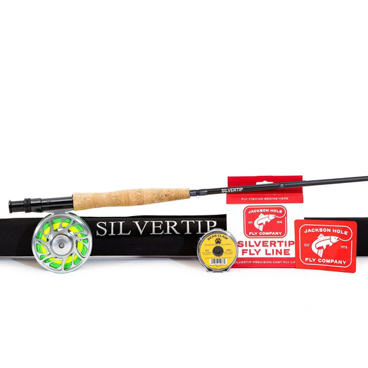 The Jackson Hole Fly Company Bass Smasher Rod Combo Kit – 86 6WT includes a reel, black Silvertip carrying case, Silvertip fly line packaging, yellow line spool, and two red Jackson Hole Fly Company stickers.